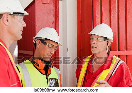 Engineers in brainstorming session on oil rig View Large Photo Image Stock Photo - Engineers in brainstorming session on oil rig. Fotosearch