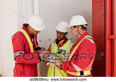 Engineers in brainstorming session on oil rig View Large Photo Image Stock Photograph - Engineers in brainstorming session on oil rig. Fotosearch