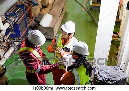 Engineers in brainstorming session on oil rig View Large Photo Image Stock Photography - Engineers in brainstorming session on oil rig. Fotosearch