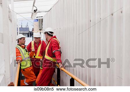 Engineers in brainstorming session on oil rig View Large Photo Image Stock Photography - Engineers in brainstorming session on oil rig. Fotosearch