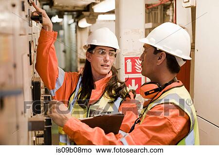 Picture - Engineers in discussion on oil rig. Fotosearch