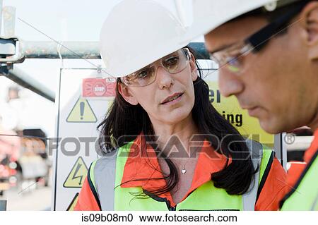 Engineers in discussion on oil rig View Large Photo Image Stock Image - Engineers in discussion on oil rig. Fotosearch