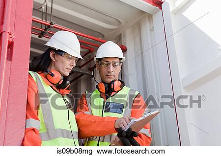 Engineers in discussion on oil rig View Large Photo Image Stock Image - Engineers in discussion on oil rig. Fotosearch