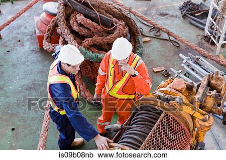 Engineers in discussion on oil rig View Large Photo Image Stock Image - Engineers in discussion on oil rig. Fotosearch