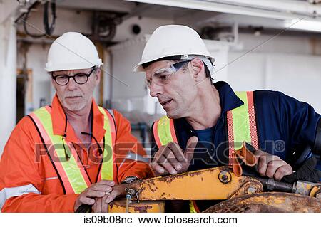 Engineers in discussion on oil rig View Large Photo Image Stock Image - Engineers in discussion on oil rig. Fotosearch