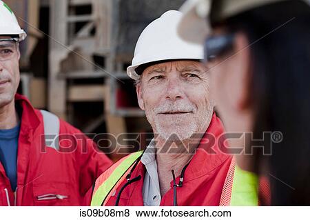 Engineers in discussion on oil rig View Large Photo Image Stock Photo - Engineers in discussion on oil rig. Fotosearch