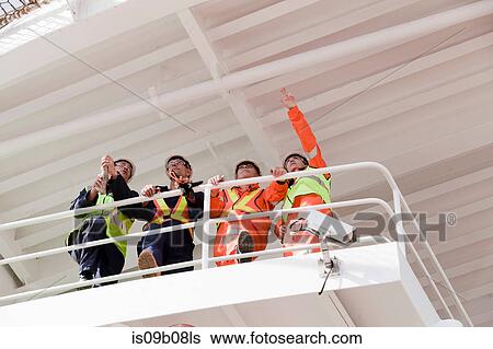 Engineers in discussion on oil rig View Large Photo Image Stock Photograph - Engineers in discussion on oil rig. Fotosearch