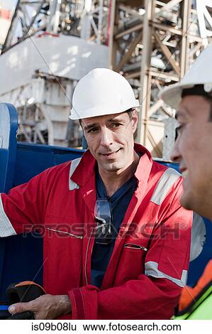 Engineers in discussion on oil rig View Large Photo Image Stock Photograph - Engineers in discussion on oil rig. Fotosearch