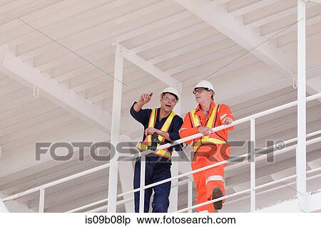 Engineers in discussion on oil rig View Large Photo Image Stock Photography - Engineers in discussion on oil rig. Fotosearch