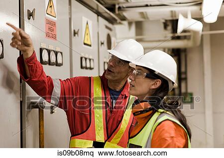 Stock Photography - Engineers in discussion on oil rig. Fotosearch