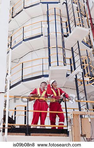 Stock Photo - Engineers working on oil rig. Fotosearch