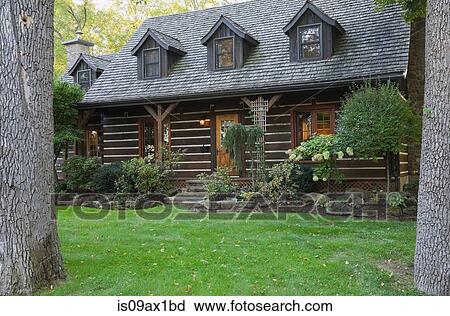 Stock Image - Exterior of Canadian cottage style home with cedar shingles and garden. Fotosearch