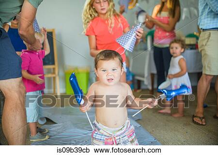 Stock Image - Family at birthday celebration. Fotosearch