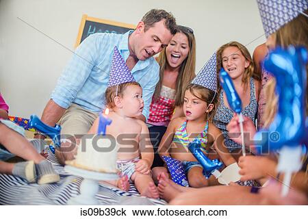 Stock Image - Family at birthday celebration. Fotosearch