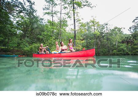 Stock Image - Family on a canoe trip together at Econfina Spring, Florida, USA. Fotosearch