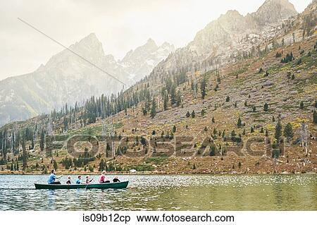 Stock Photography - Family with four children paddling canoe on lake, Grand Teton National Park, Wyoming, USA. Fotosearch