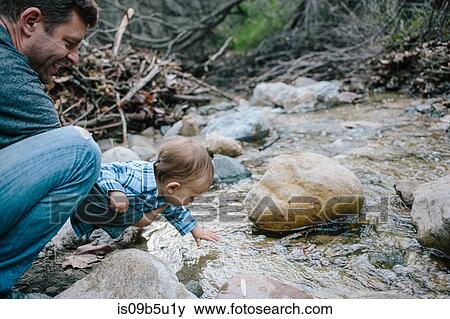 Father and baby boy investigating river, Venice Beach, Los Angeles, California, USA View Large Photo Image Stock Photo - Father and baby boy investigating river, Venice Beach, Los Angeles, California, USA. Fotosearch