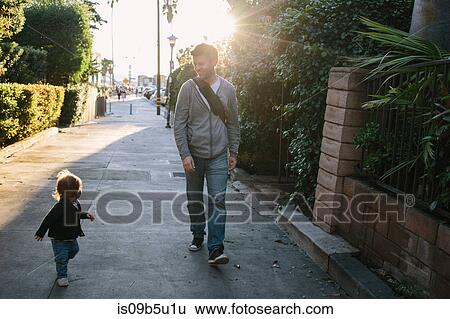 Father and baby boy walking in residential street, Venice Beach, Los Angeles, California, USA View Large Photo Image Stock Photograph - Father and baby boy walking in residential street, Venice Beach, Los Angeles, California, USA. Fotosearch