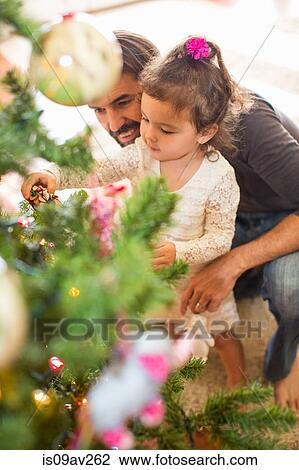 Father and daughter decorating Christmas tree View Large Photo Image Stock Image - Father and daughter decorating Christmas tree. Fotosearch