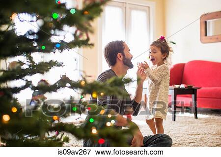 Father and daughter decorating christmas tree View Large Photo Image Stock Photo - Father and daughter decorating christmas tree. Fotosearch