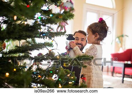 Father and daughter decorating christmas tree View Large Photo Image Stock Photograph - Father and daughter decorating christmas tree. Fotosearch