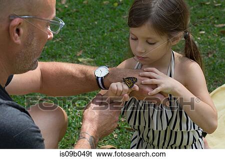 Father and daughter looking at monarch butterfly View Large Photo Image Stock Photograph - Father and daughter looking at monarch butterfly. Fotosearch