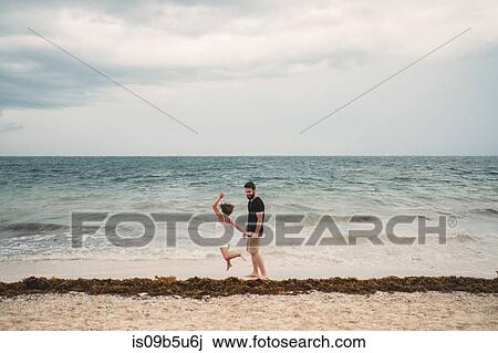 Father and daughter playing on beach, Cancun, Mexico View Large Photo Image Stock Image - Father and daughter playing on beach, Cancun, Mexico. Fotosearch