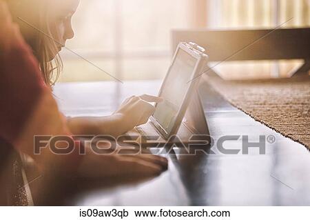 Father and daughter using wireless digital tablet at home View Large Photo Image Stock Image - Father and daughter using wireless digital tablet at home. Fotosearch