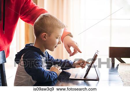 Father and son using wireless digital tablet at home View Large Photo Image Stock Photo - Father and son using wireless digital tablet at home. Fotosearch