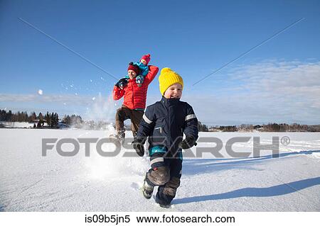 Father and two sons fooling around, running through snow covered landscape View Large Photo Image Stock Photography - Father and two sons fooling around, running through snow covered landscape. Fotosearch