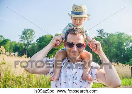 Father carrying baby boy on shoulders View Large Photo Image Stock Image - Father carrying baby boy on shoulders. Fotosearch