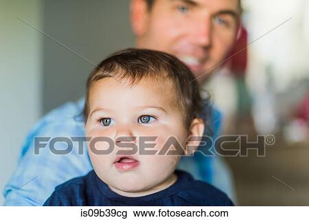 Father carrying toddler in arms View Large Photo Image Stock Image - Father carrying toddler in arms. Fotosearch