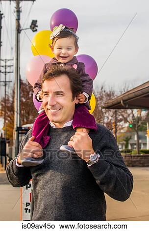 Father carrying young daughter on shoulders, smiling View Large Photo Image Picture - Father carrying young daughter on shoulders, smiling. Fotosearch