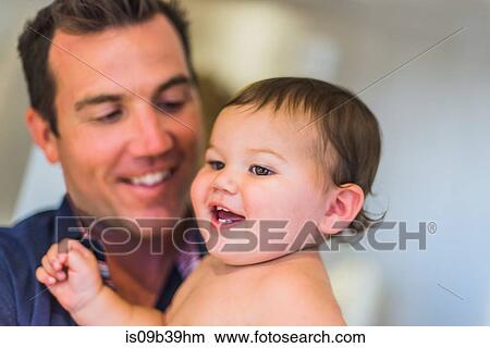Father laughing with son in arms View Large Photo Image Picture - Father laughing with son in arms. Fotosearch
