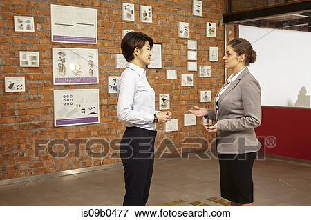Female asian worker and caucasian female manager in gallery of printing and packaging factory, China View Large Photo Image Stock Photo - Female asian worker and caucasian female manager in gallery of printing and packaging factory, China. Fotosearch