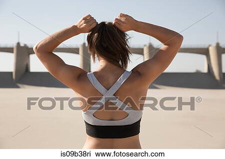 Stock Image - Female athlete stretching, Van Nuys, California, USA. Fotosearch