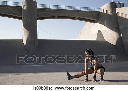 Female athlete with headphones, stretching, Van Nuys, California, USA View Large Photo Image Stock Image - Female athlete with headphones, stretching, Van Nuys, California, USA. Fotosearch