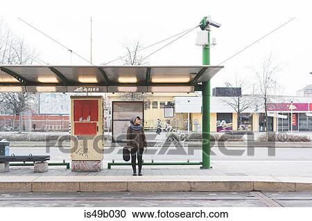 Female backpacker standing at city bus station View Large Photo Image Stock Image - Female backpacker standing at city bus station. Fotosearch