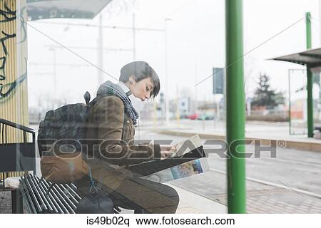 Female backpacker waiting at bus station looking at map View Large Photo Image Stock Photography - Female backpacker waiting at bus station looking at map. Fotosearch