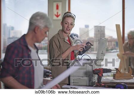 Female carpenter discussing equipment with trainee in furniture making workshop View Large Photo Image Stock Image - Female carpenter discussing equipment with trainee in furniture making workshop. Fotosearch