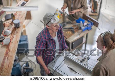 Female carpenter showing equipment to trainee in furniture making workshop View Large Photo Image Stock Image - Female carpenter showing equipment to trainee in furniture making workshop. Fotosearch