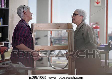Female carpenters carrying bookshelves in furniture making workshop View Large Photo Image Stock Photography - Female carpenters carrying bookshelves in furniture making workshop. Fotosearch