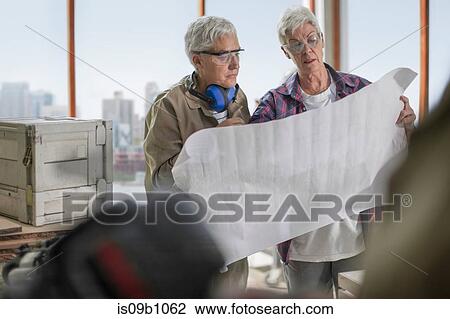 Female carpenters discussing blueprint design in furniture making workshop View Large Photo Image Stock Image - Female carpenters discussing blueprint design in furniture making workshop. Fotosearch