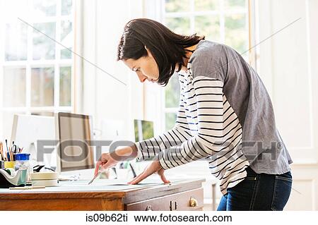 Female designer cutting paper with scalpel in creative studio View Large Photo Image Stock Image - Female designer cutting paper with scalpel in creative studio. Fotosearch
