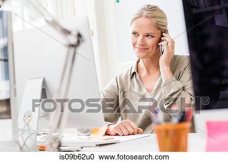 Female designer making smartphone call in creative studio View Large Photo Image Stock Image - Female designer making smartphone call in creative studio. Fotosearch