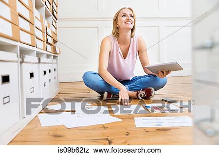 Female designer sitting on floor creating mood board in creative studio View Large Photo Image Stock Photo - Female designer sitting on floor creating mood board in creative studio. Fotosearch