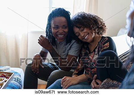 Female friends relaxing at home View Large Photo Image Stock Photograph - Female friends relaxing at home. Fotosearch