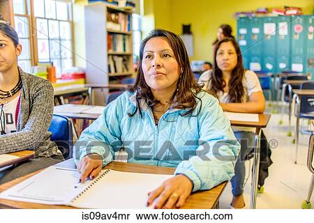 Stock Photography - Female mature students listening from class desks. Fotosearch