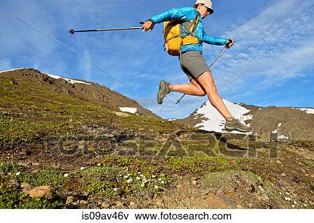 Female mountain climber jumping downhill, Chugach State Park, Anchorage, Alaska, USA View Large Photo Image Stock Photo - Female mountain climber jumping downhill, Chugach State Park, Anchorage, Alaska, USA. Fotosearch