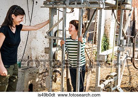 Female organic farmer with boy in animal stall at dairy farm View Large Photo Image Stock Photograph - Female organic farmer with boy in animal stall at dairy farm. Fotosearch